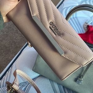 Is a guess bag with the wallet. Is light pink almost cream.